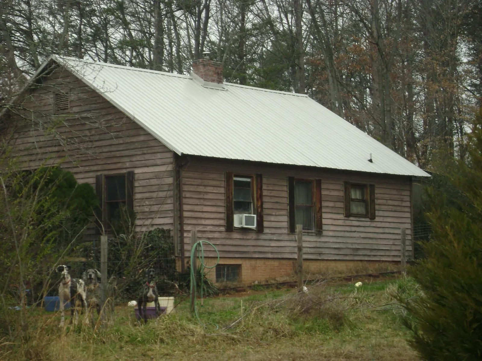 White metal roof on an old wood sided farmhouse, from a Metal Roof Installation job in Cumberland Furnace